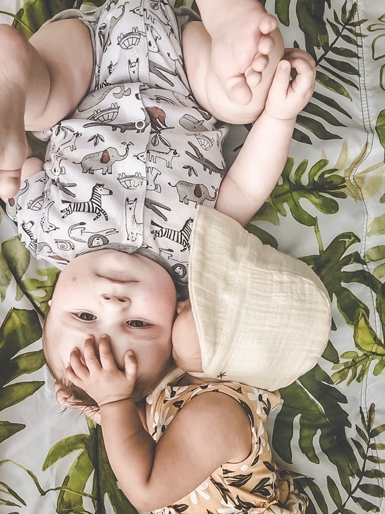 babies laying on a blanket baby bonnet