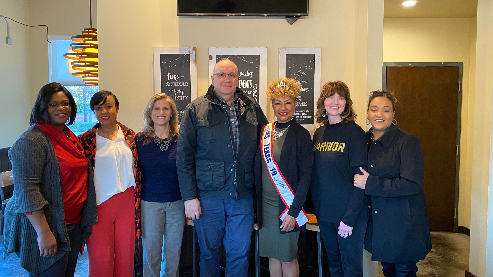 Diana Romero standing with a group of friends talking about bringing faith to work in corporate America