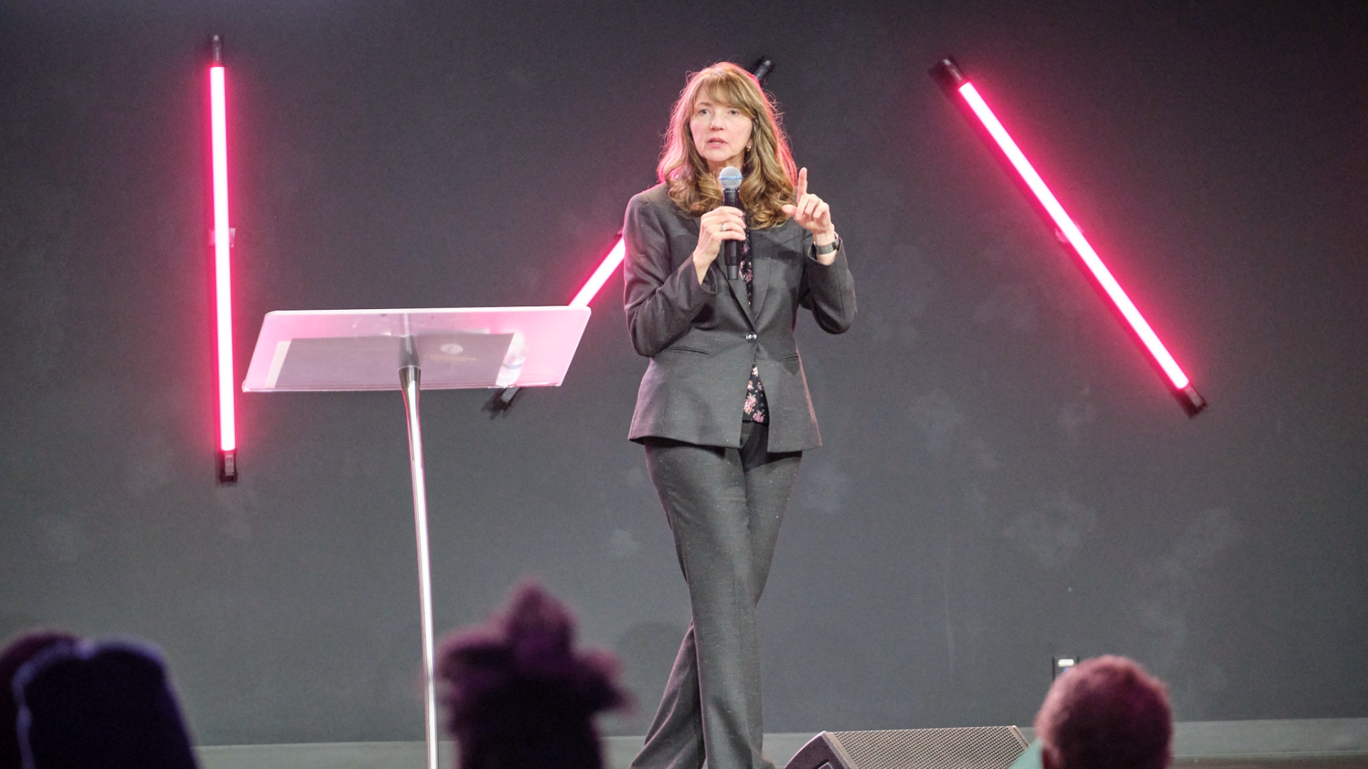 Diana Romero speaking on stage about faith work integration